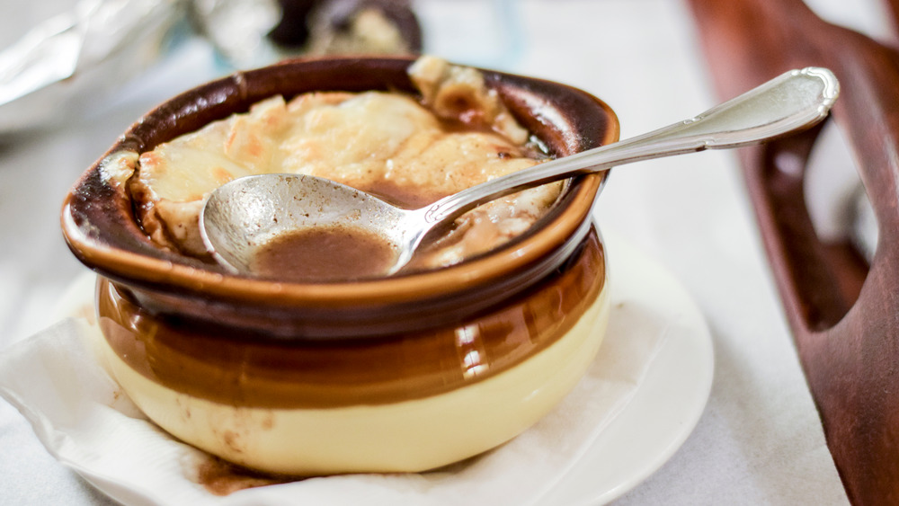 French onion soup in a bowl with spoon