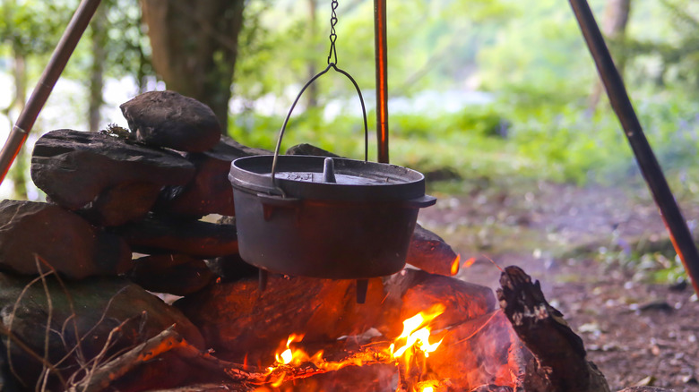 Pot of stew hanging over campfire