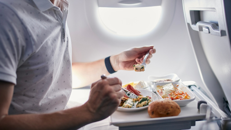 Man eating airline food