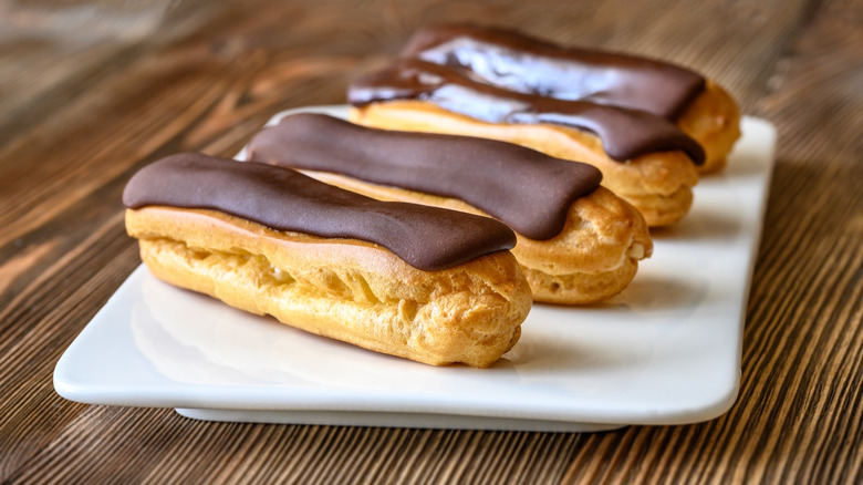 four eclairs on plate