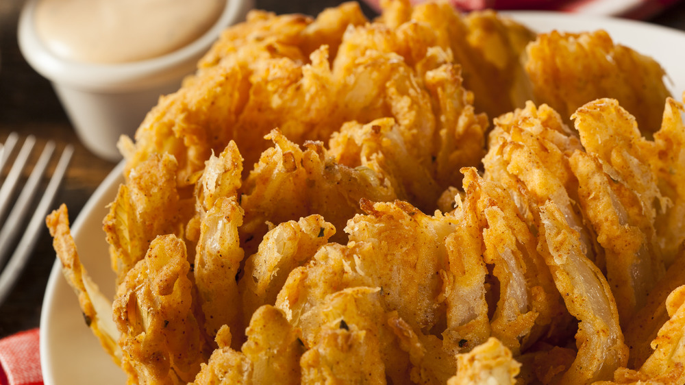 fried onion on plate with sauce