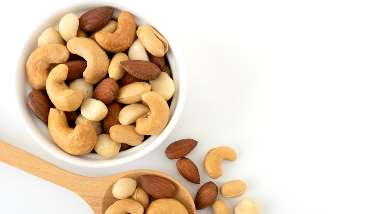 raw nuts mix in bowl and spoon