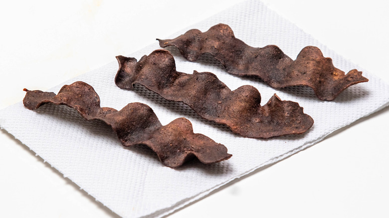 Burnt bacon on a napkin