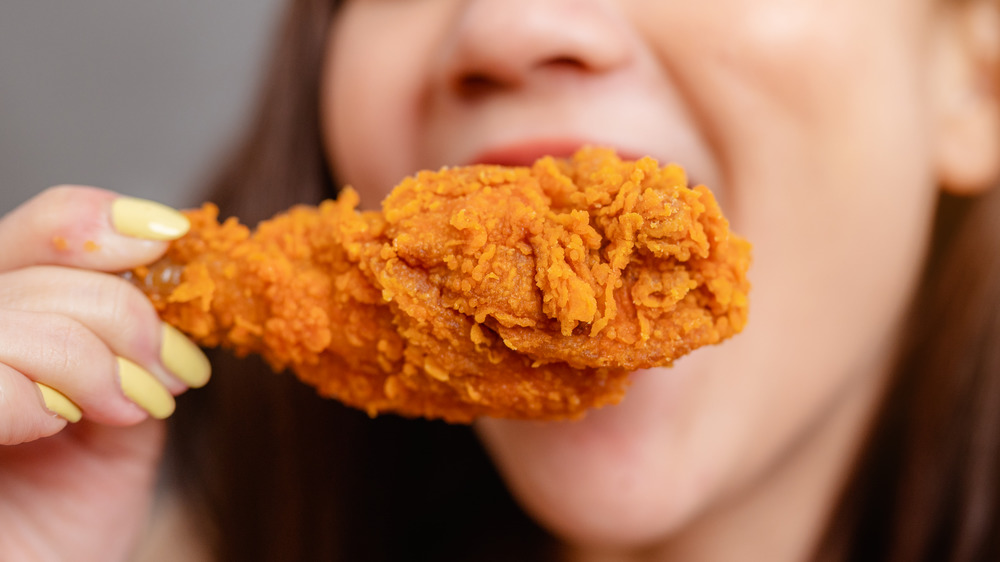 Person eating fried chicken