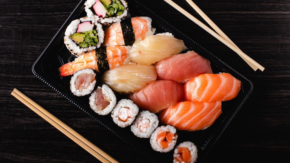 Sushi in black tray with chopsticks