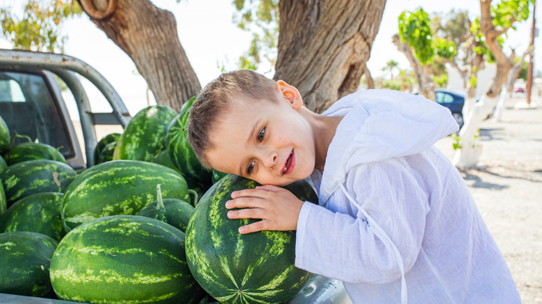 Boy listening to watermelon