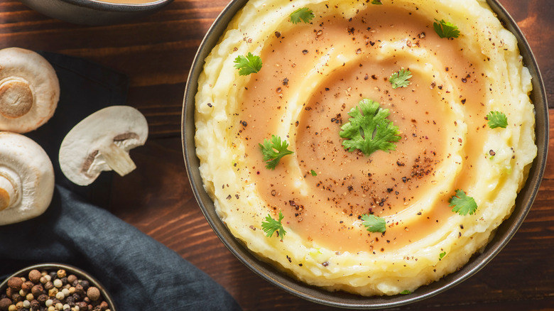 Mushrooms beside a bowl of mashed potatoes