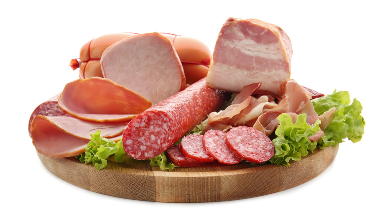 A selection of cold meats on a wooden tray