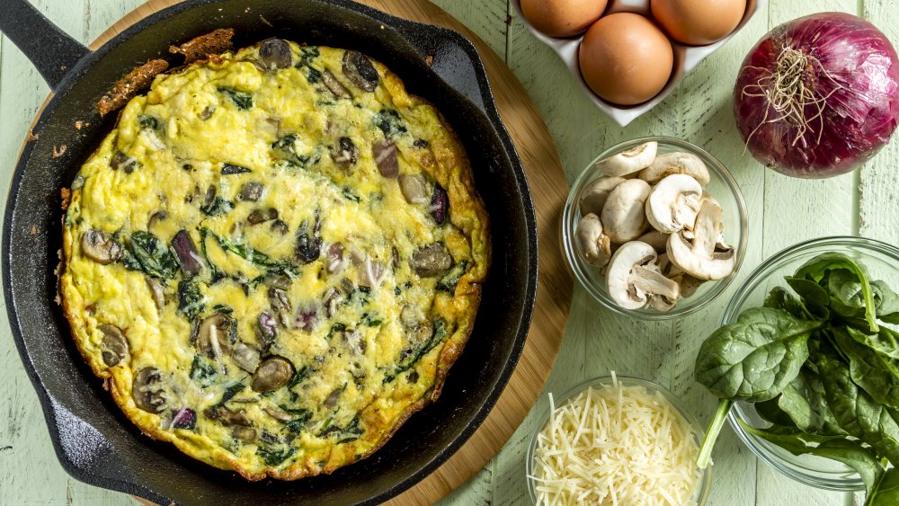 Spinach, mushroom, and onion frittata in a cast iron pan
