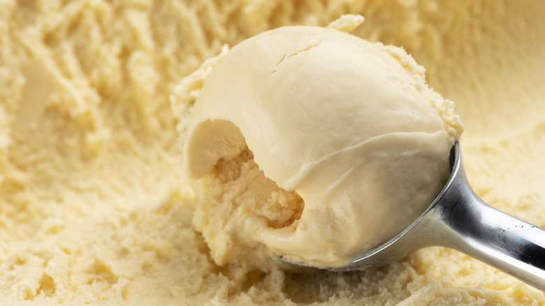 Silver scoop in vanilla ice cream