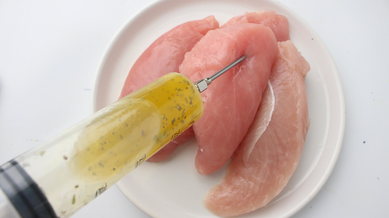 injecting marinade into raw turkey breast