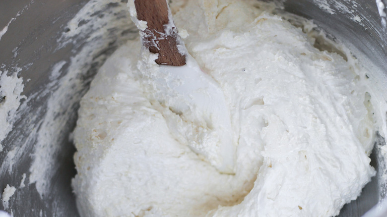 macaron batter with spoon in mixing bowl