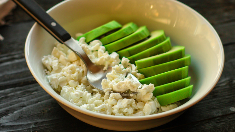 bowl of cottage cheese and sliced avocados