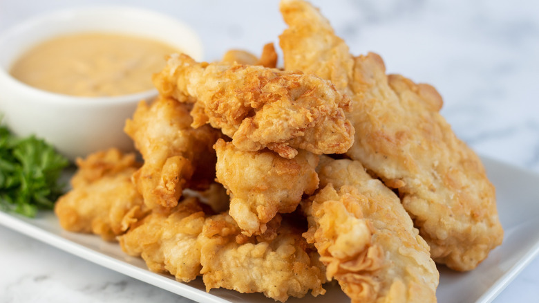 breaded chicken tenders on plate