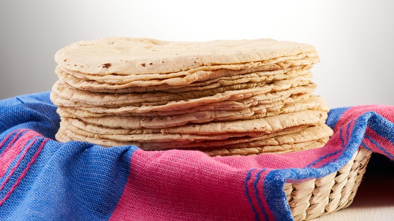 Corn tortillas stacked on fabric