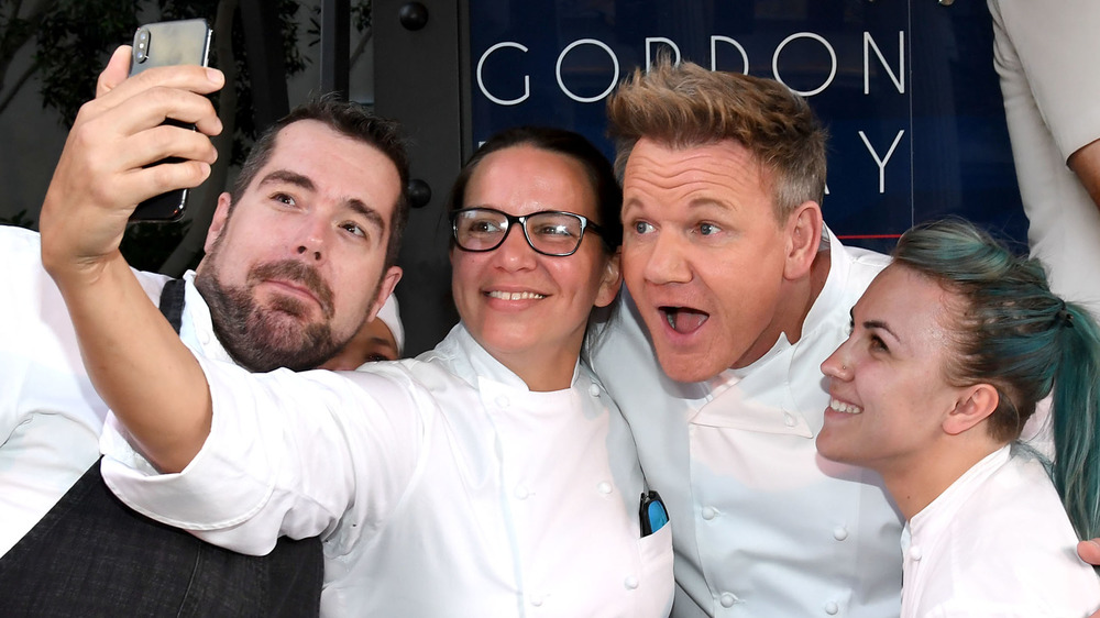 Hell's Kitchen contestants posing with Gordon Ramsay