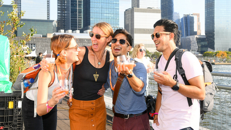 four friends holding drinks at NYCWFF