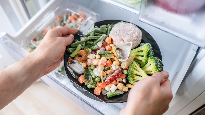 Two hands holding frozen meal