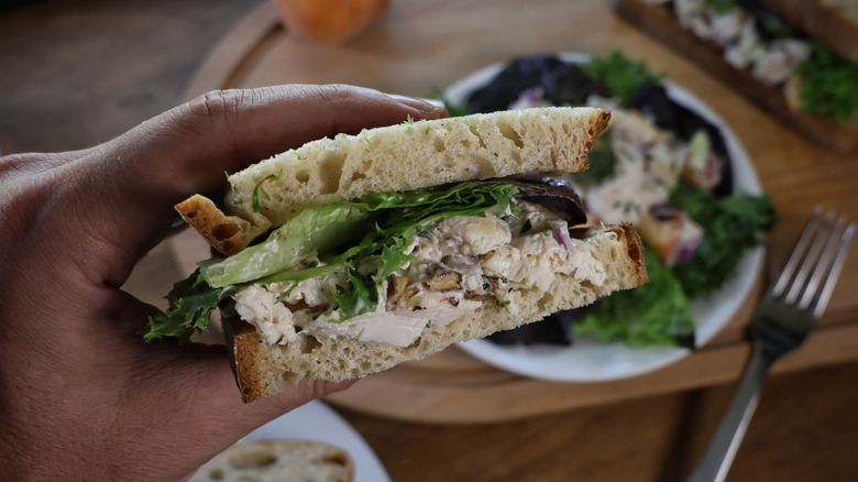 chicken salad sandwich in hand