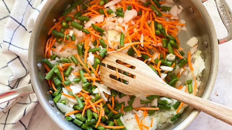 carrots, green beans and onions in pan