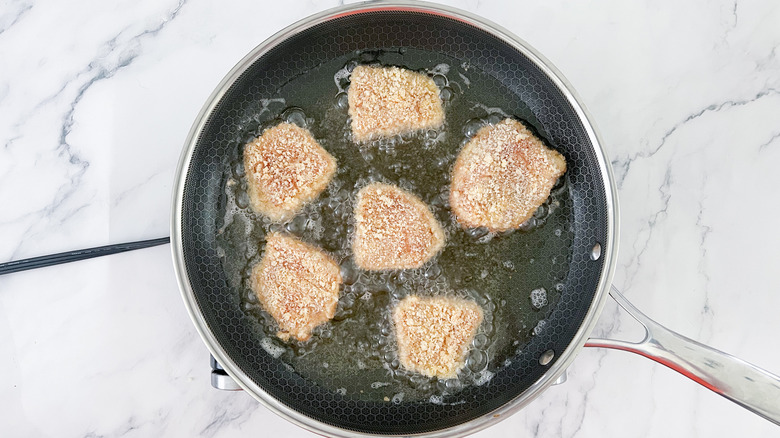 chicken frying in large skillet