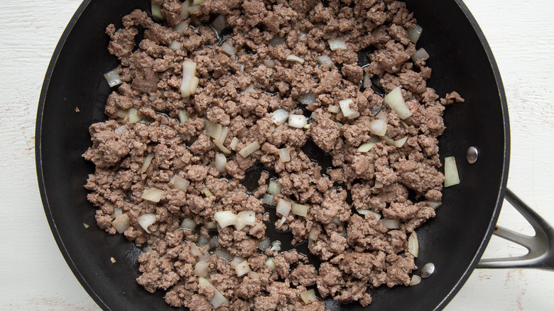 cooking meat in a skillet