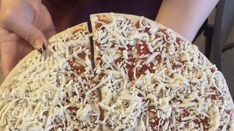 a frozen pizza broken in half