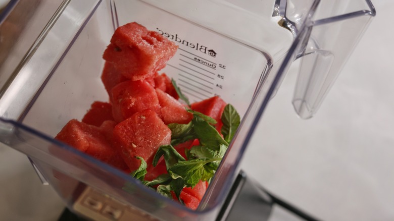 blender full of mint and frozen watermelon