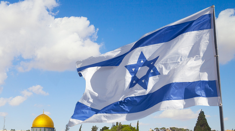 Israel flag blowing over blue sky