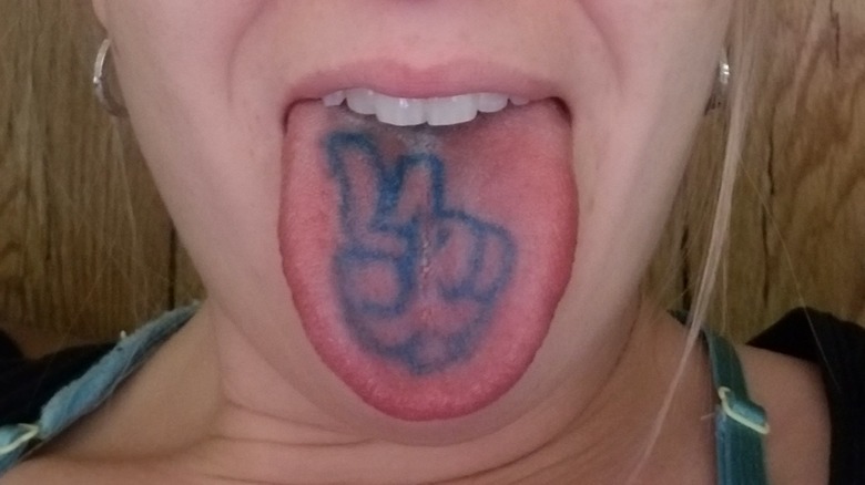 Tongue tattoo shown by woman