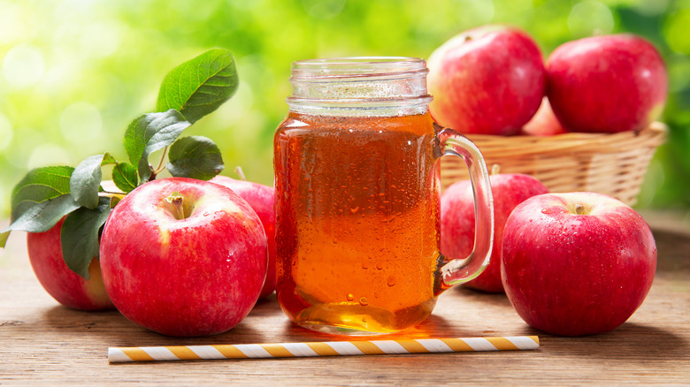 apple juice surrounded by fresh red apples