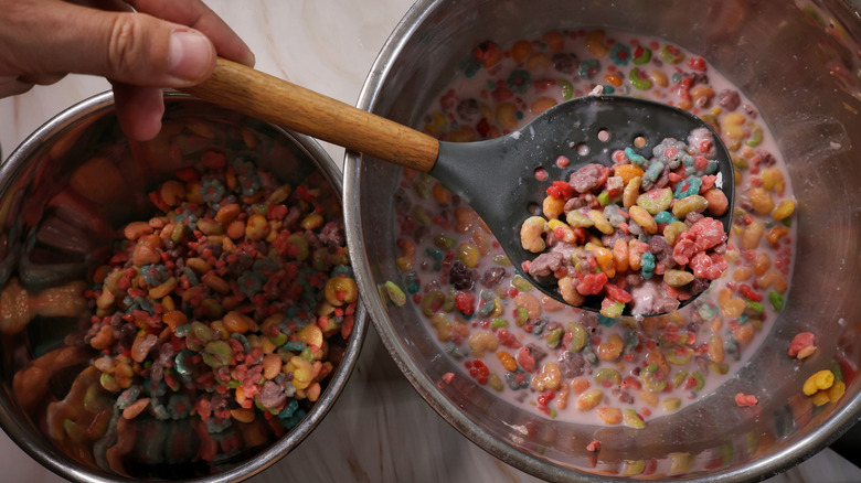 scooping cereal from mixing bowl