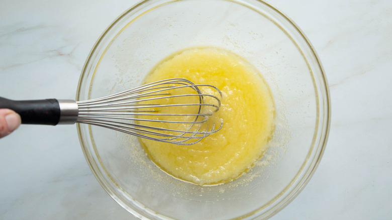 hand whisking butter and sugar