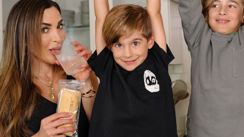 Nicole Modic with her kids drinking from a glass