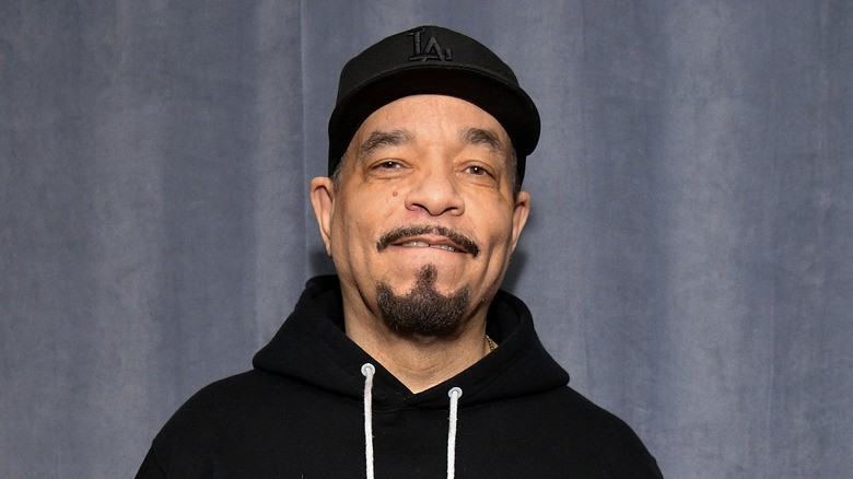 Rapper and actor Ice-T wearing a hat and hoodie