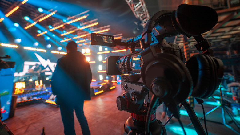 Camera in front of a blue and orange background