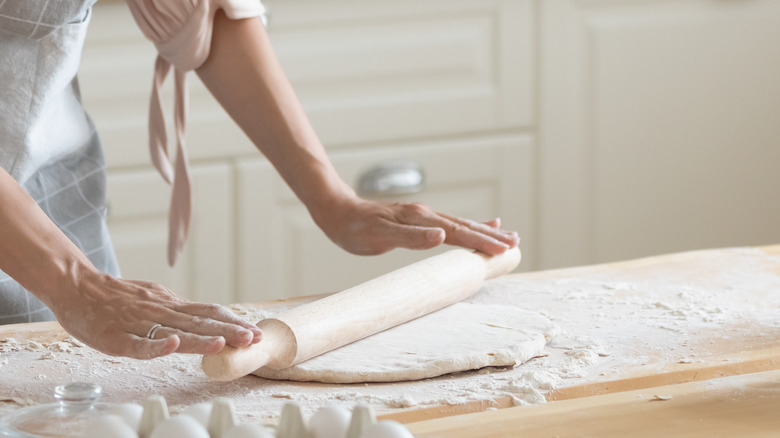 Person rolling out dough