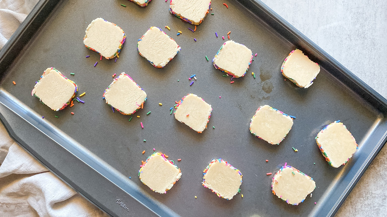 rainbow sprinkle butter cookies on baking sheet