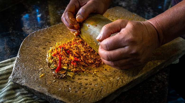 hands grinding spices