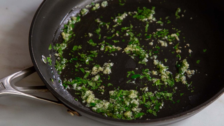 herbs and garlic in skillet