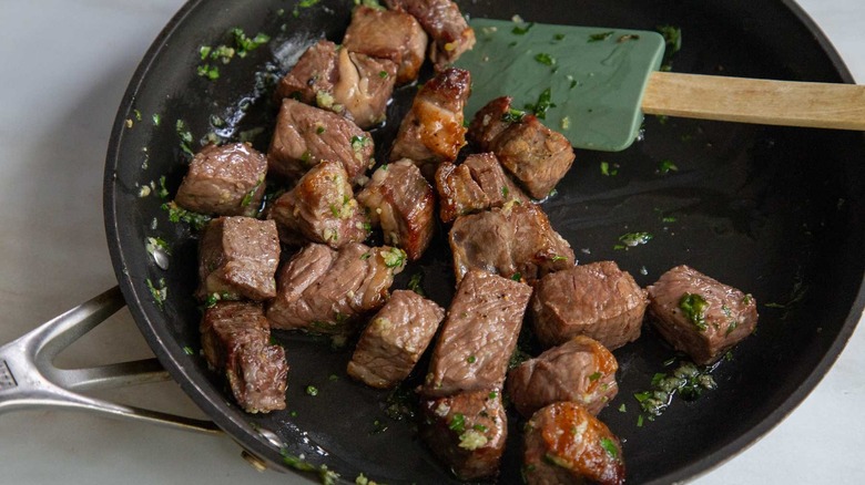 steak cubes in skillet