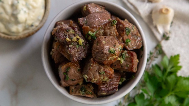 overhead shot of steak bites with garlic and herbs