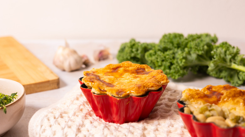 pot pie with vegetables in the background 