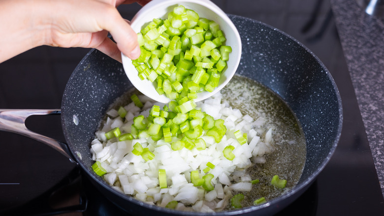 celery going into pan of onions 