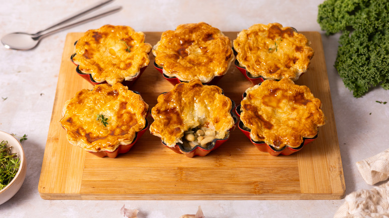 baked pot pies on wooden board