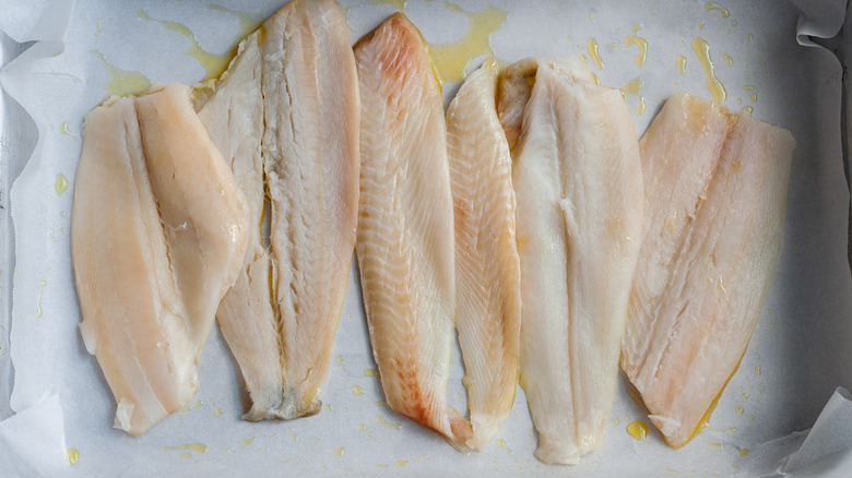 raw fish on baking sheet