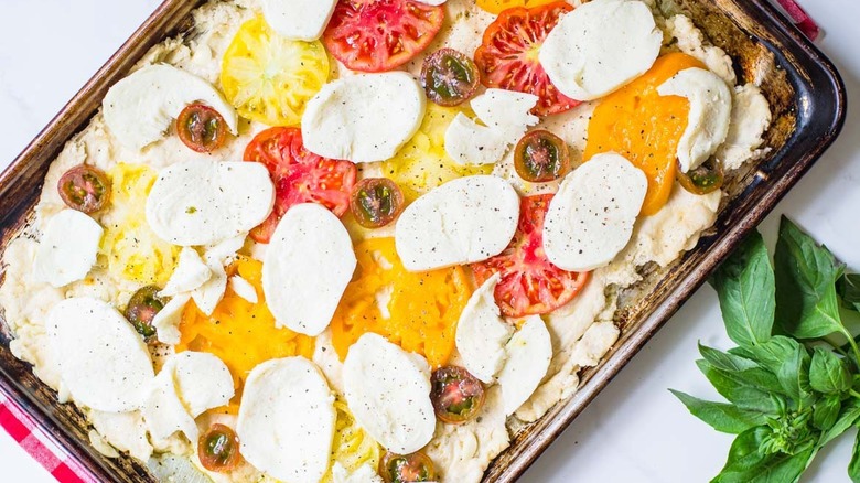 unbaked pizza on baking sheet