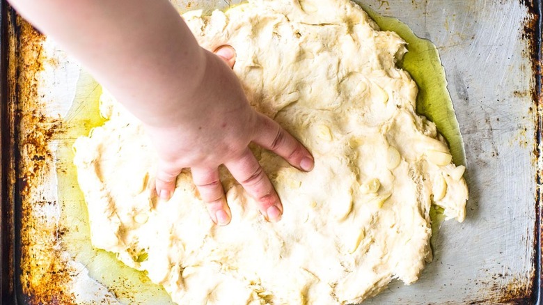 hand pressing dough