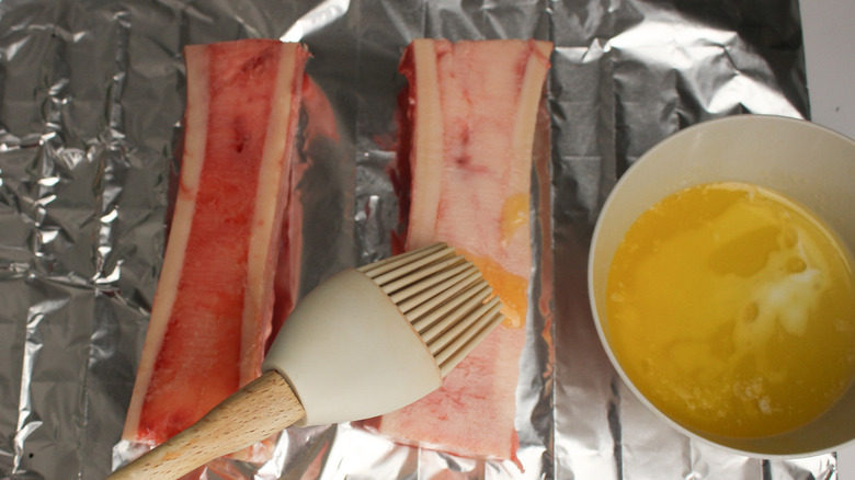 brushing butter on marrow bones