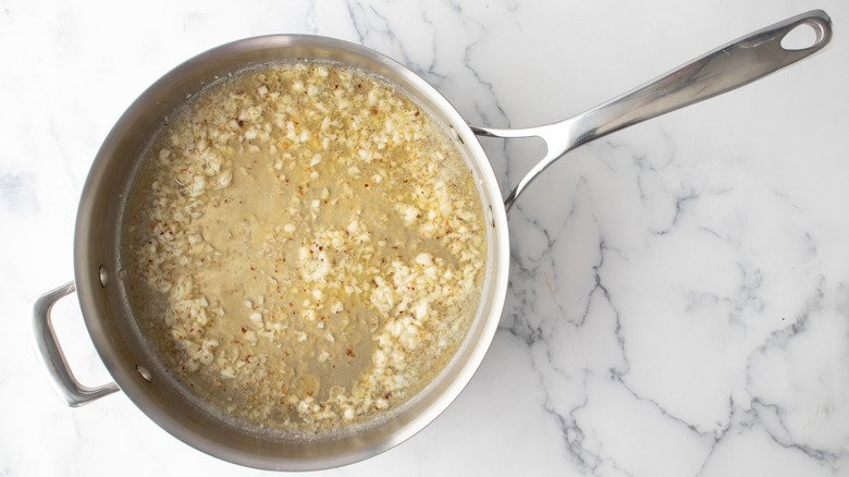 garlic butter and wine in pan